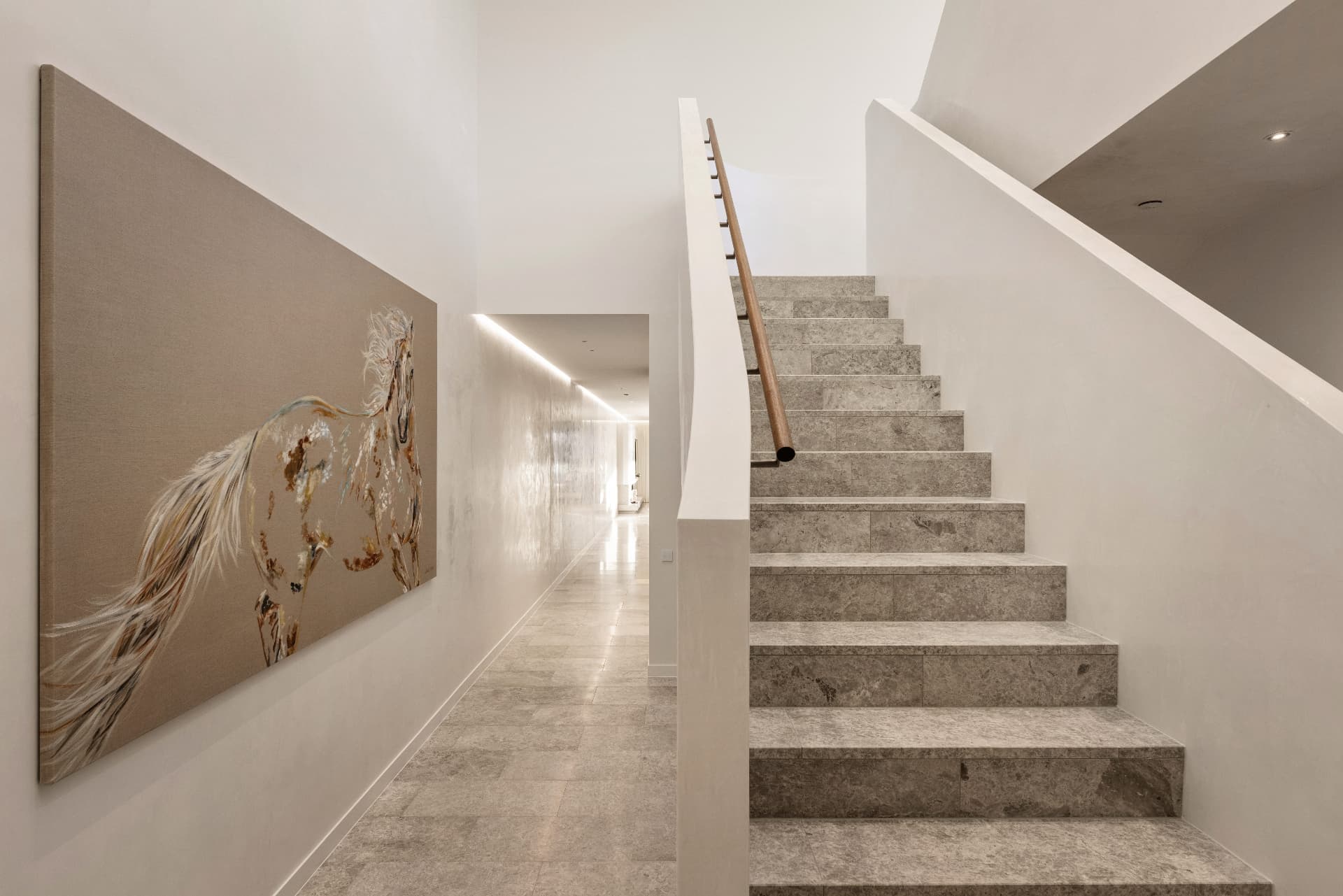 Stone staircase and hallway with feature artwork