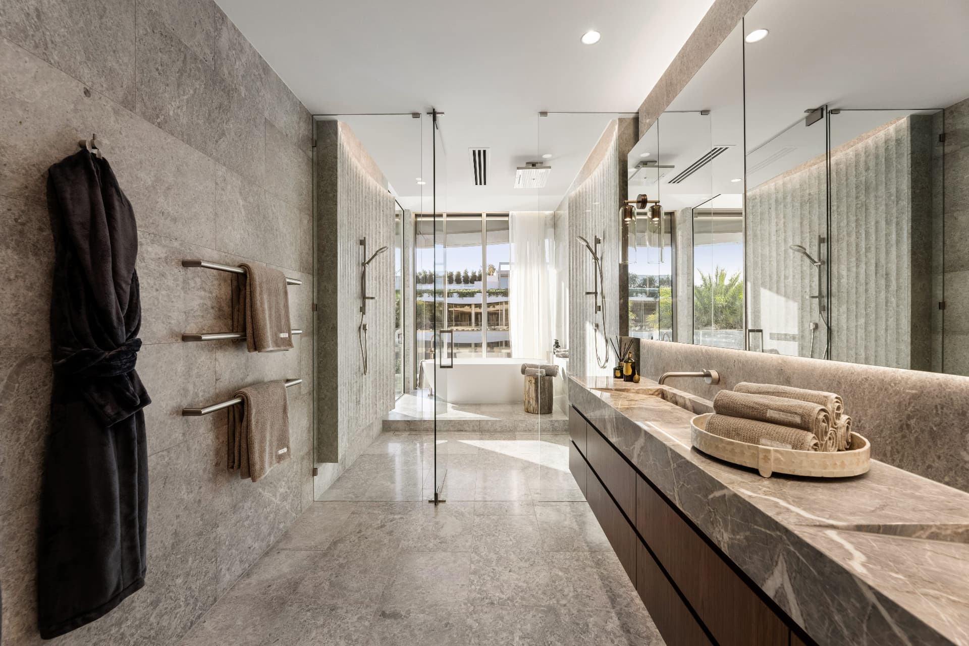 Stone ensuite with double vanity, glass shower and marina views
